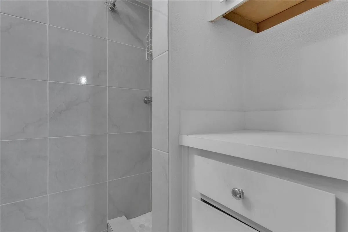 Full bathroom with tiled shower