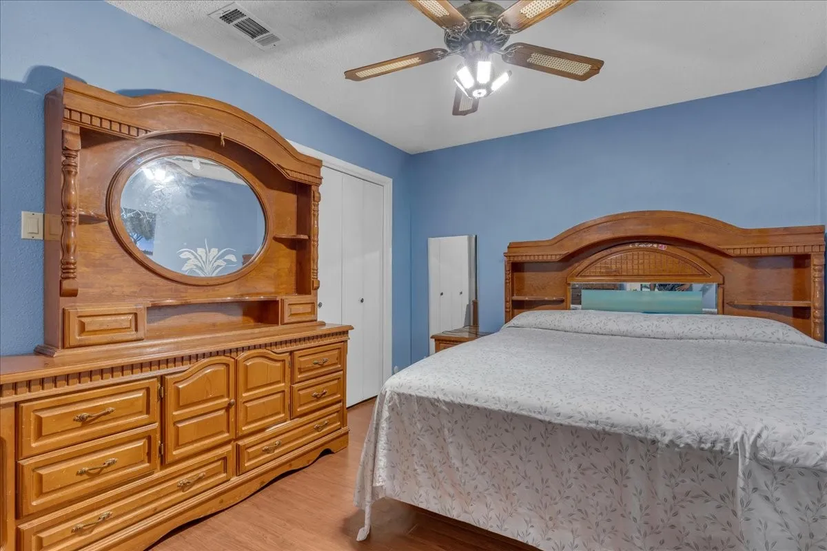 Bedroom with light wood-style flooring and a ceiling fan