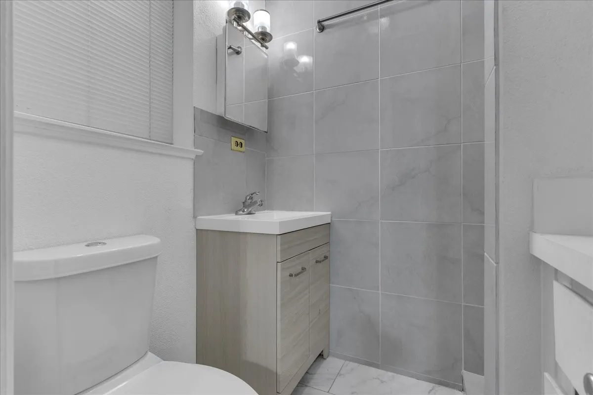 Bathroom featuring vanity and a textured wall