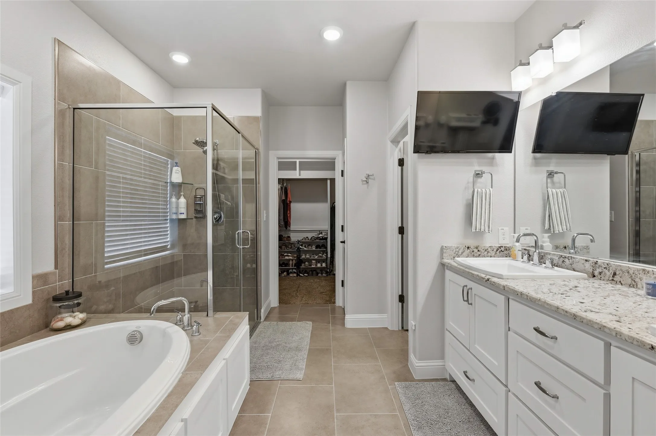 Luxury Primary Bath with Garden tub, shower, dual sinks, water closet, and a generous walk in closet