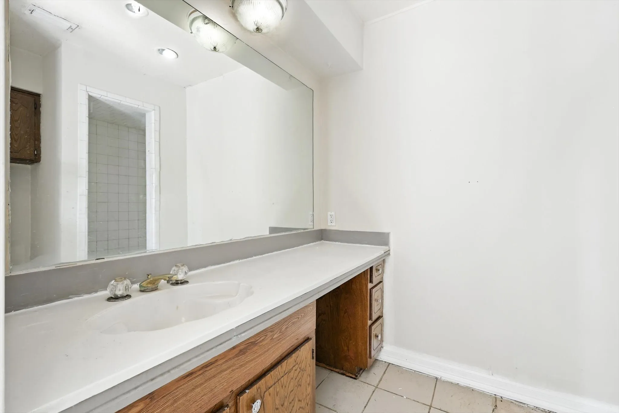 Bathroom featuring light tile patterned floors and vanity