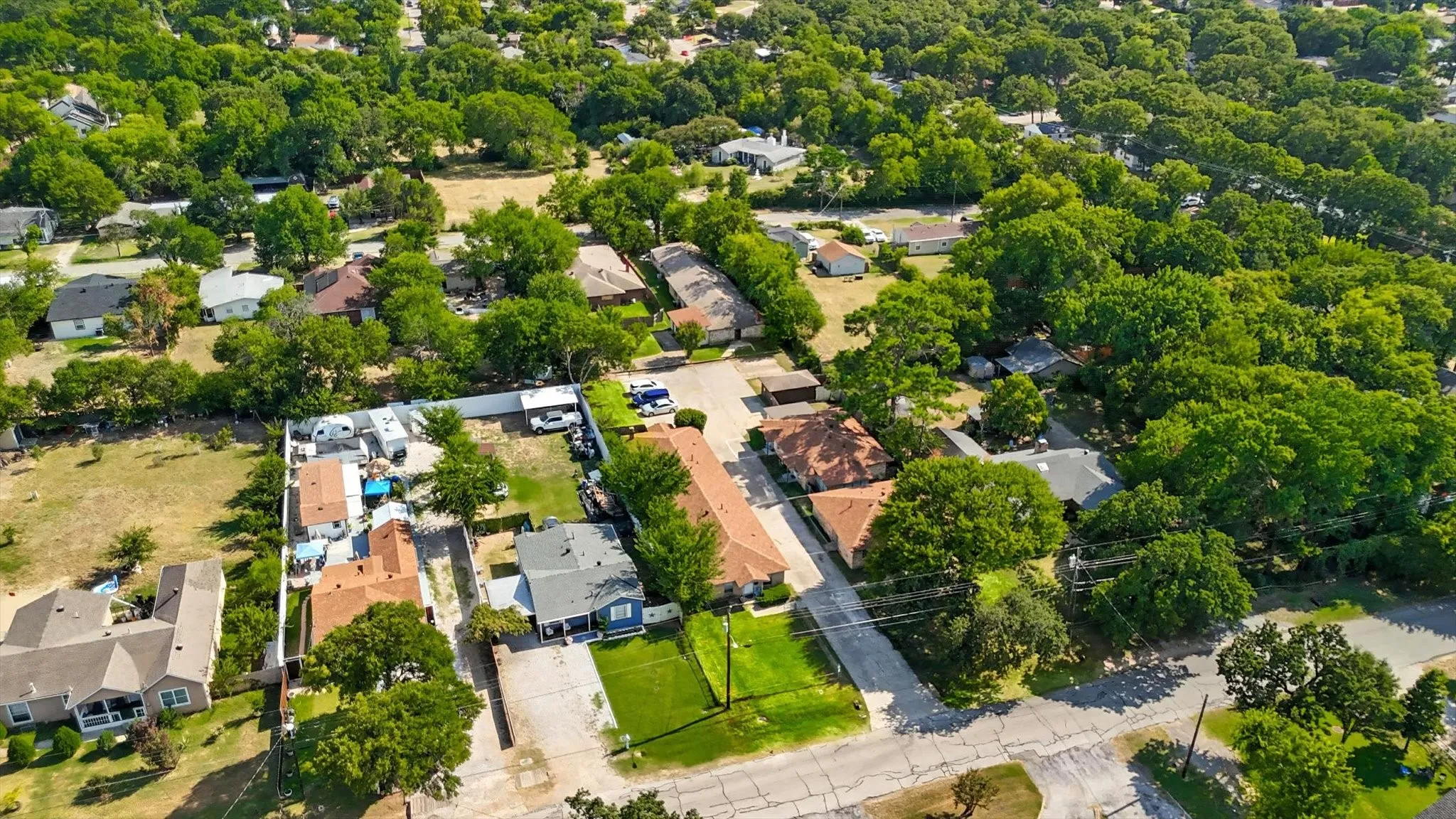 Aerial view of property and surrounding area with nearby suburban area