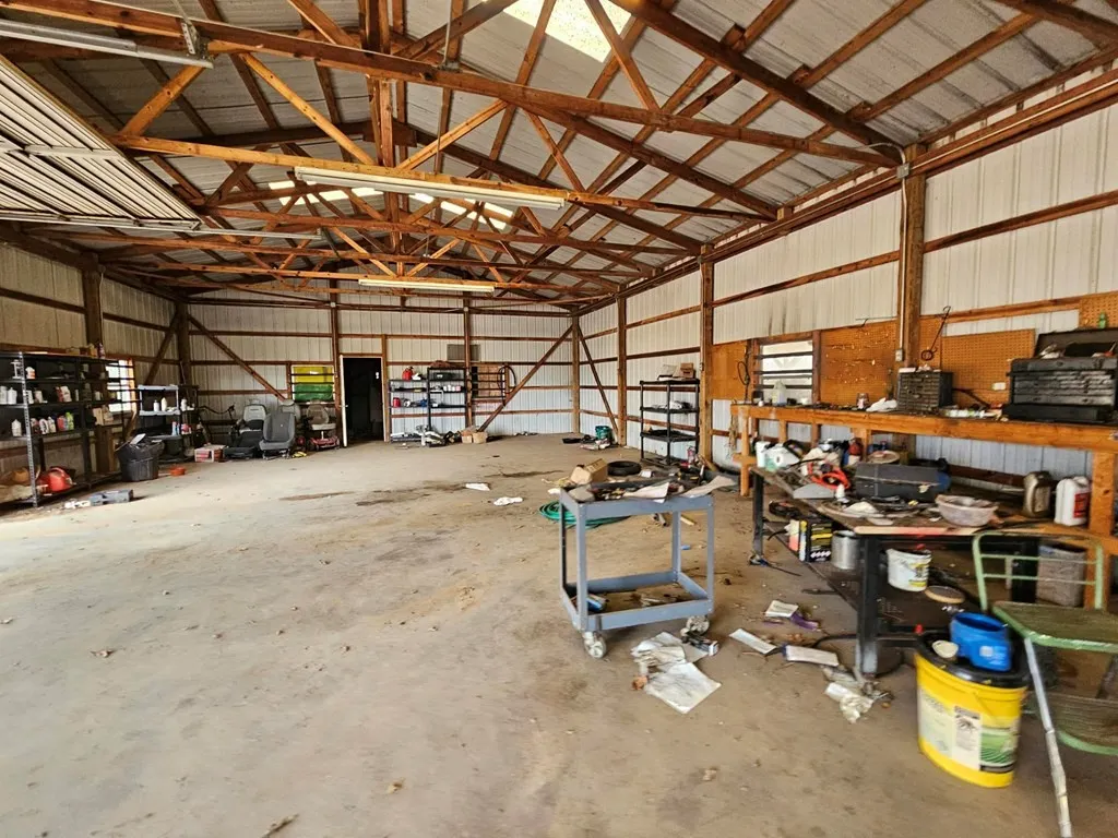 Garage with a workshop area and metal wall