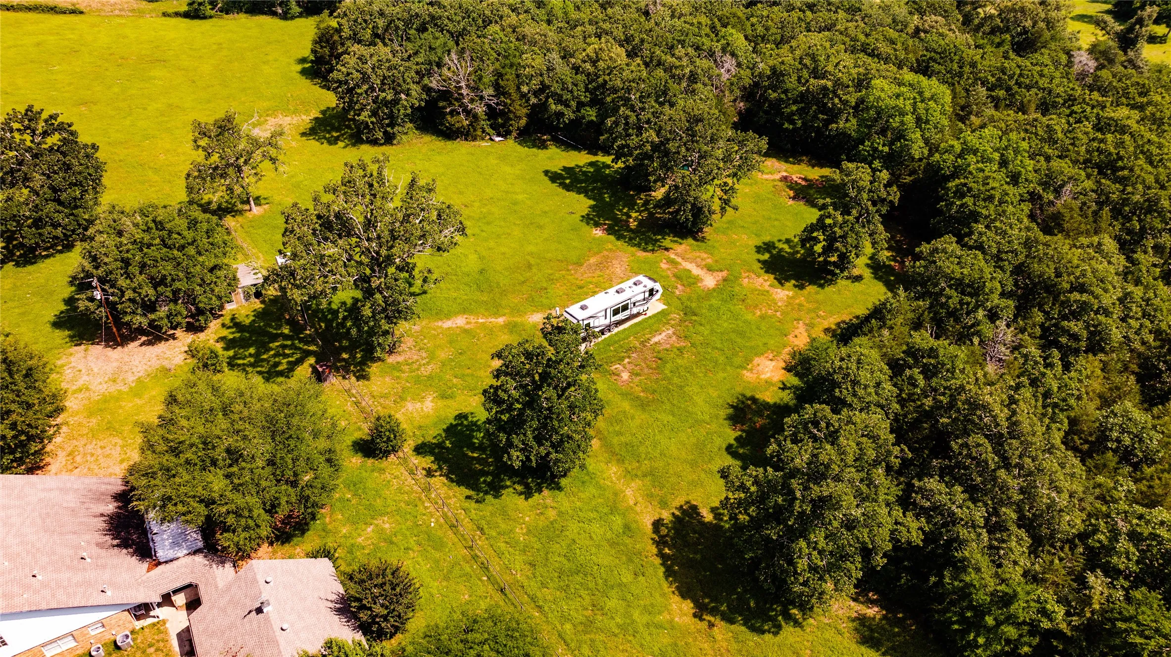 Expansive green landscape featuring varied tree cover and open grassy areas