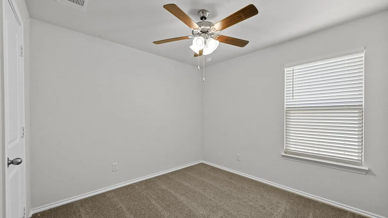 Neutral-toned carpet flooring and light gray walls create a versatile interior