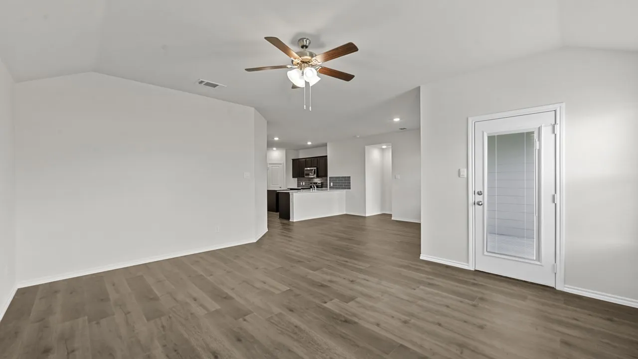 Unfurnished living room featuring a ceiling fan, dark wood-style floors, and recessed lighting