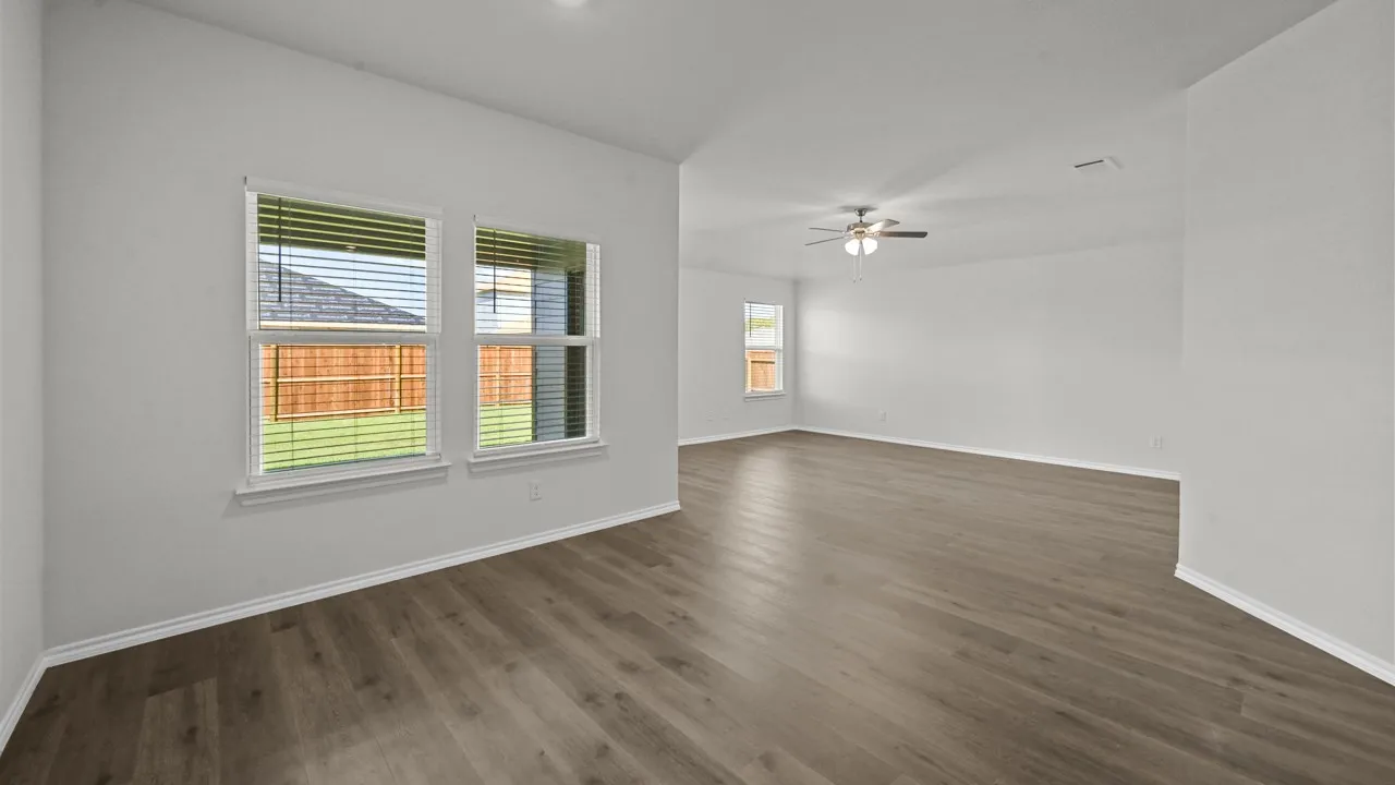Empty room featuring dark wood-style floors and a ceiling fan