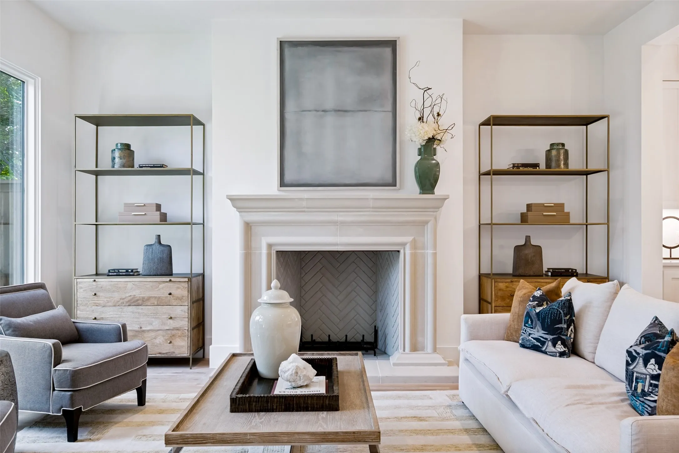 Warm Den is centered around a custom gas fireplace with cast stone mantle & surround.