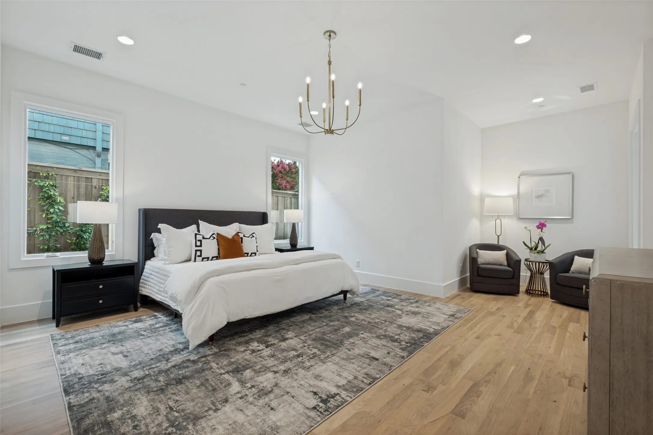 Generous sized Downstairs primary suite with seating area, spa inspired bath, oversized shower and large closet