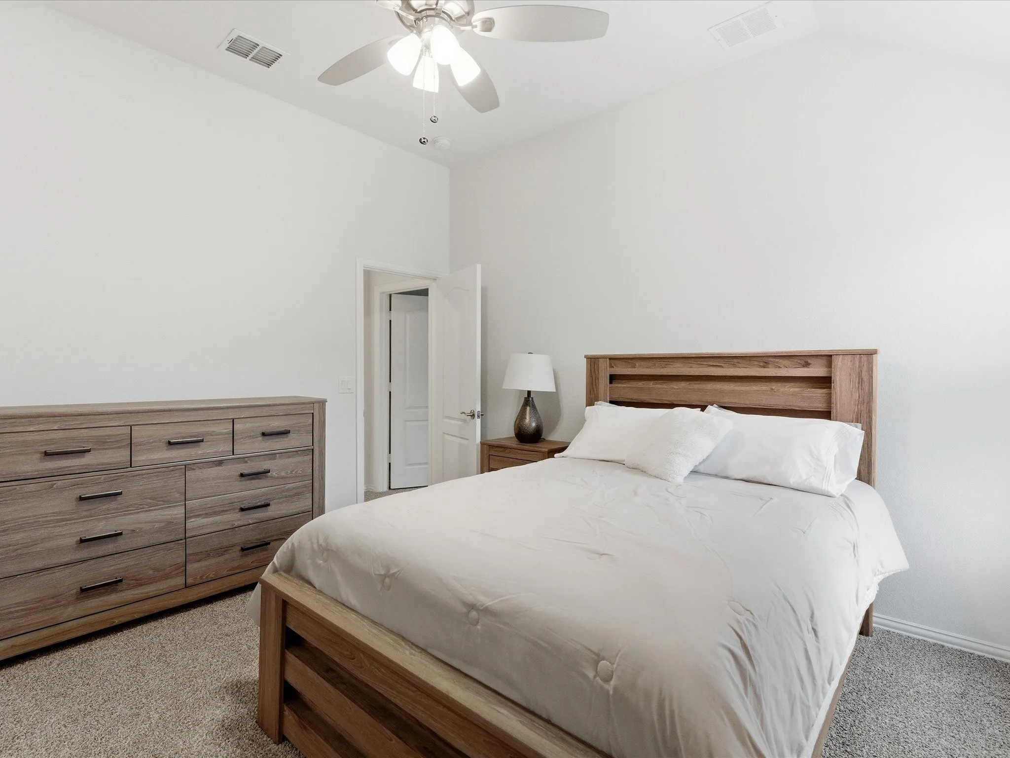 Bedroom featuring light carpet, a ceiling fan, and vaulted ceiling