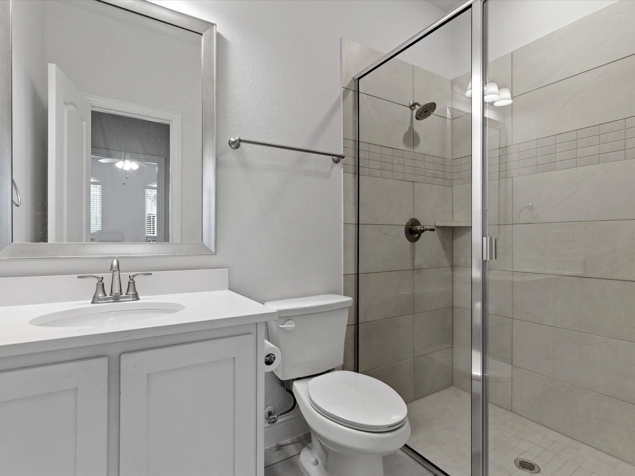 Bathroom featuring vanity and a stall shower