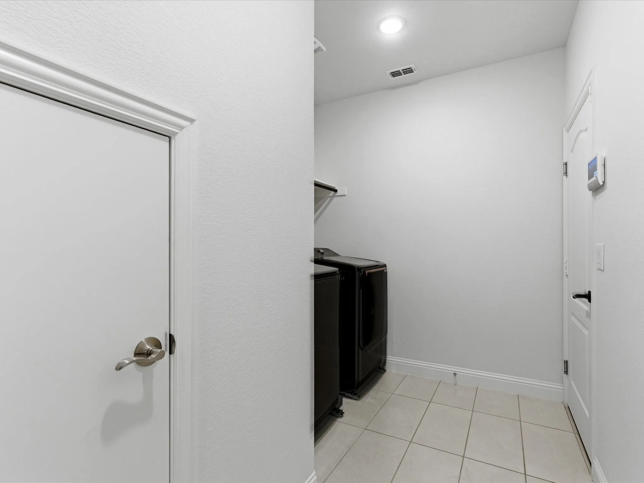 Laundry area with washing machine and clothes dryer, light tile patterned floors, and recessed lighting