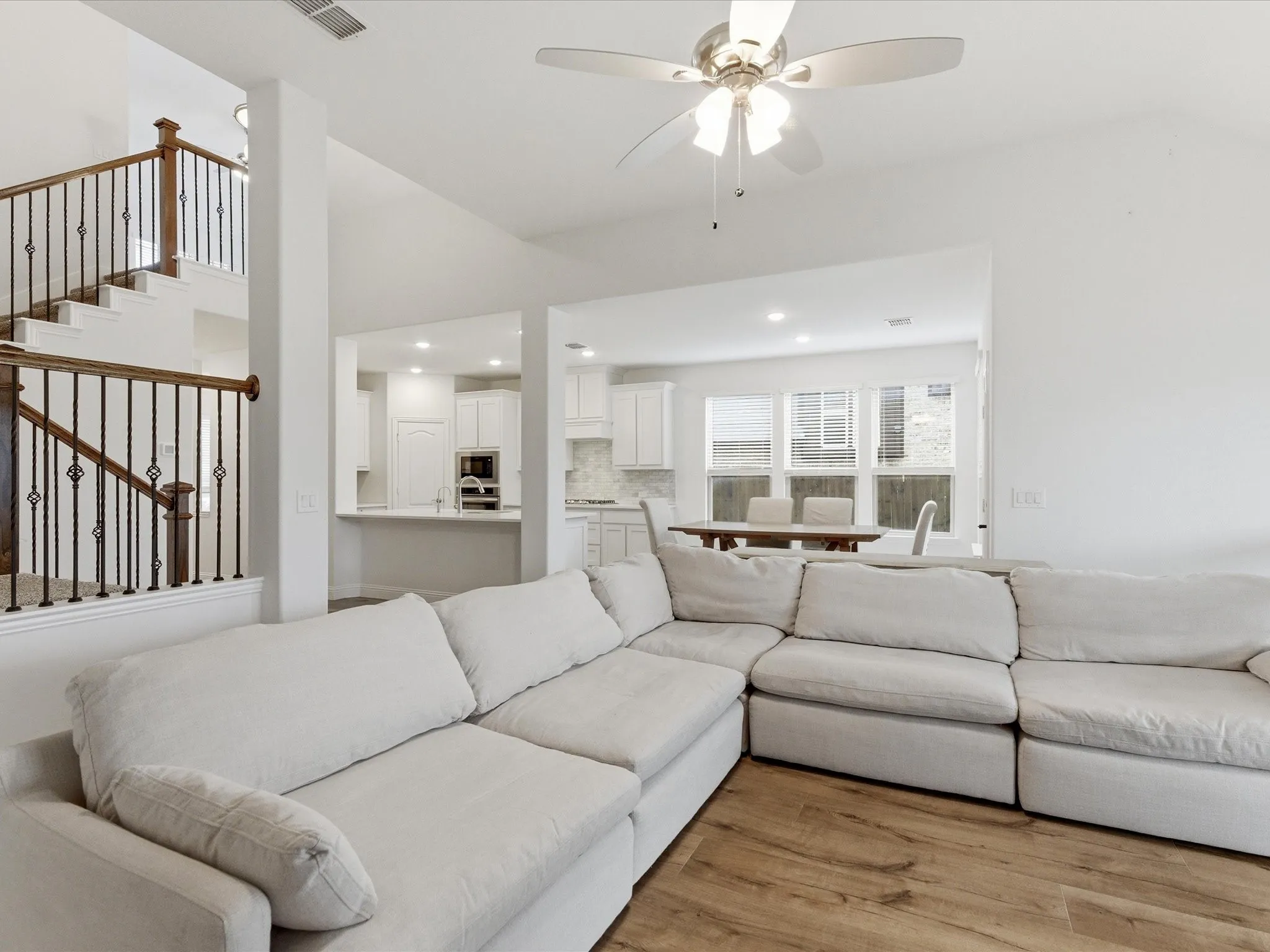 Living room featuring a ceiling fan, wood finished floors, and recessed lighting