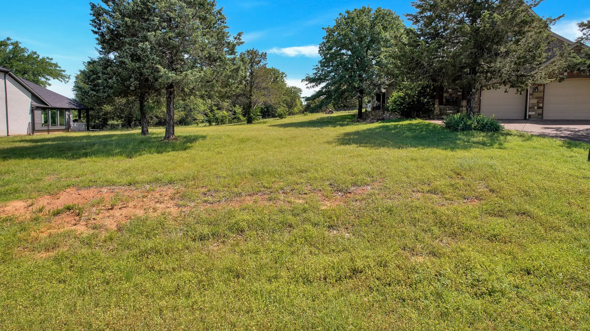 View of grassy yard with a garage