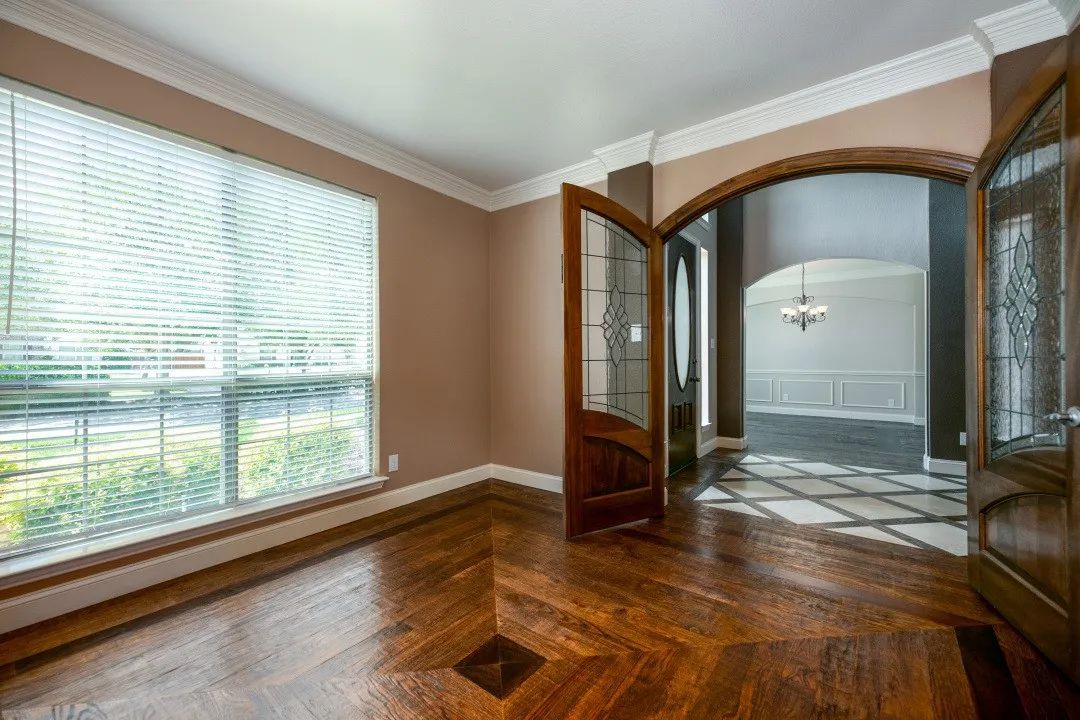 Entryway with arched walkways, parquet flooring, a chandelier, and crown molding