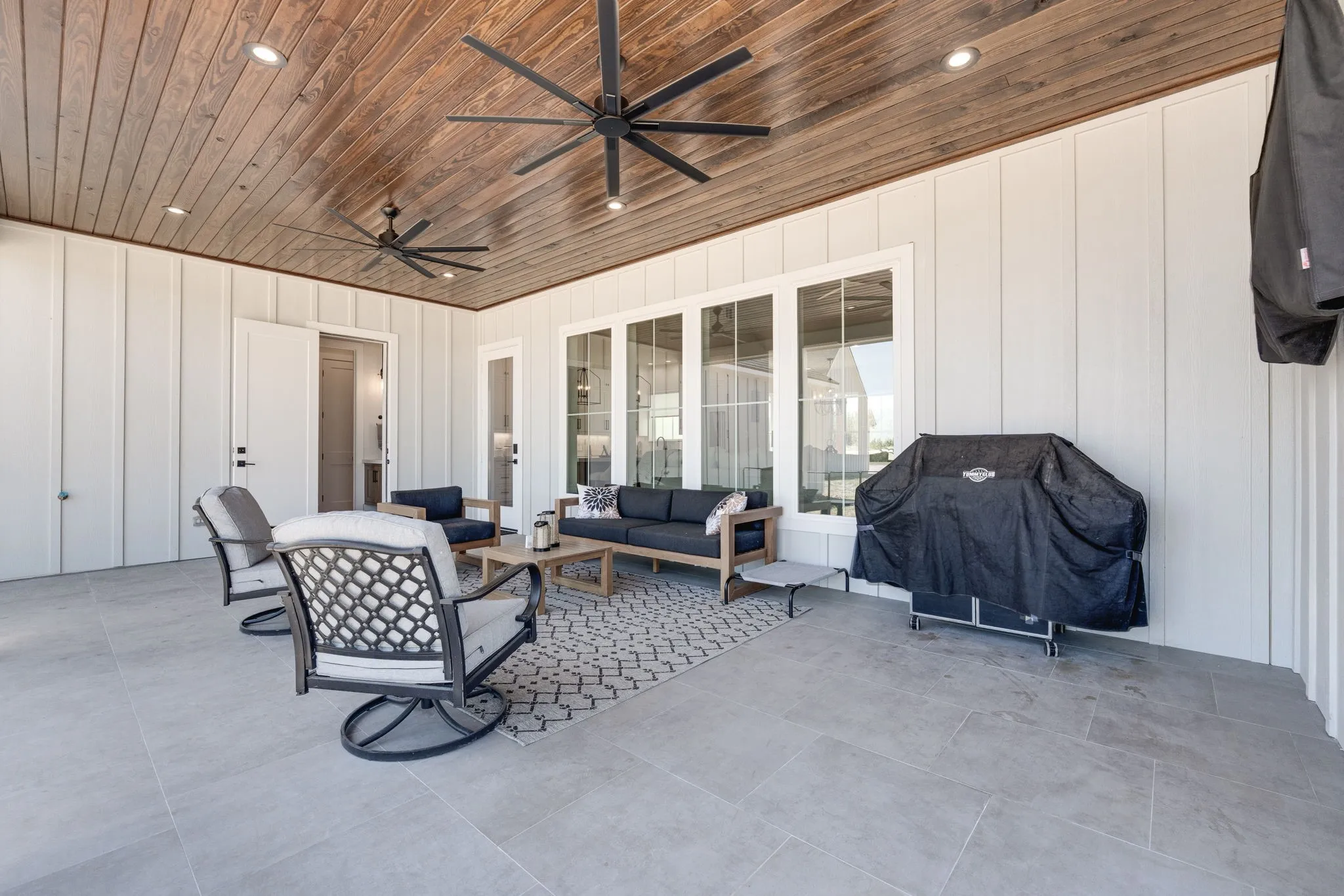 View of patio with ceiling fan, grilling area, and outdoor lounge area