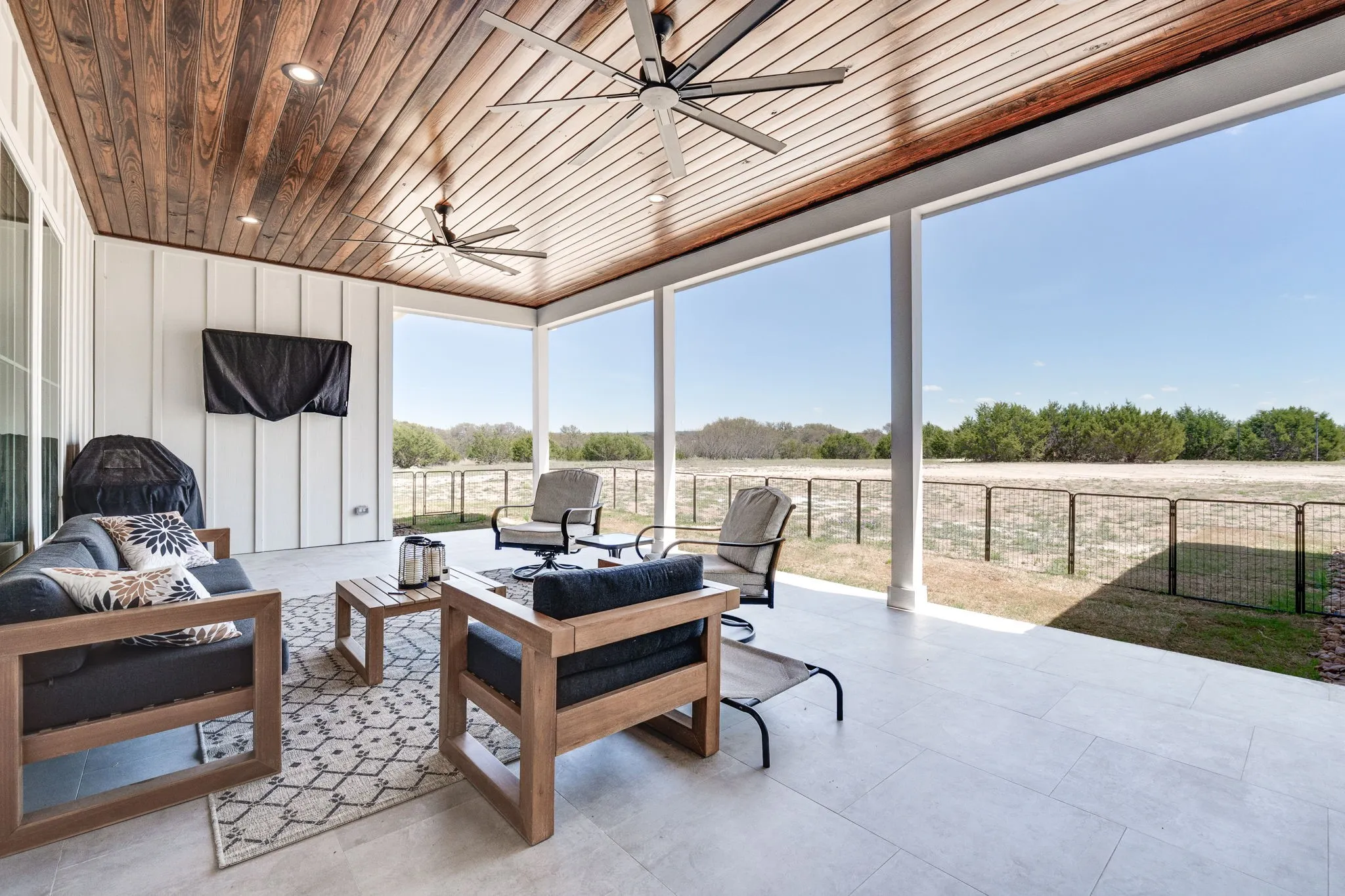 Sunroom with ceiling fan, outdoor furniture, and wooden ceiling