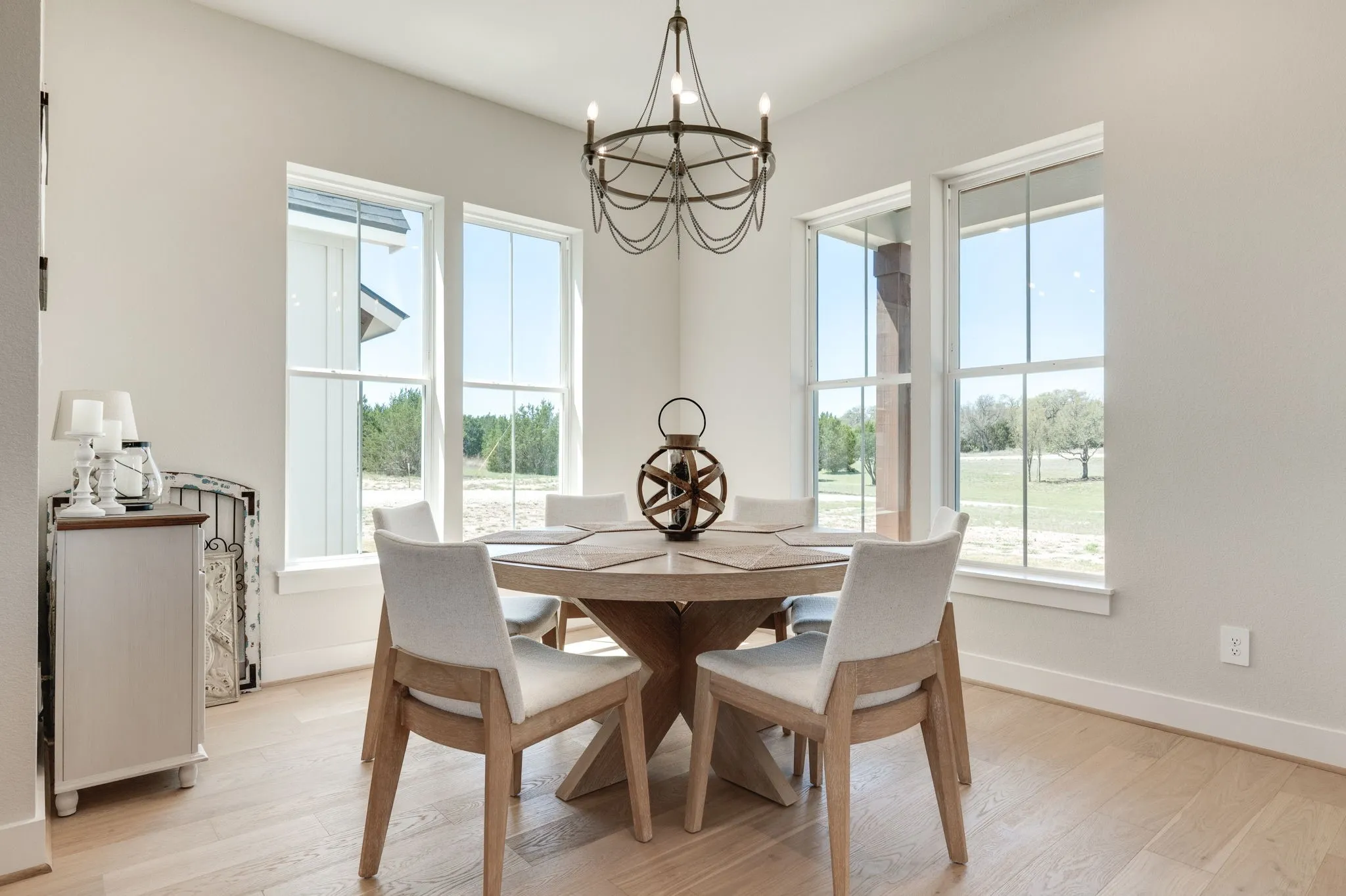 Dining space featuring a chandelier, light wood finished floors, and healthy amount of natural light