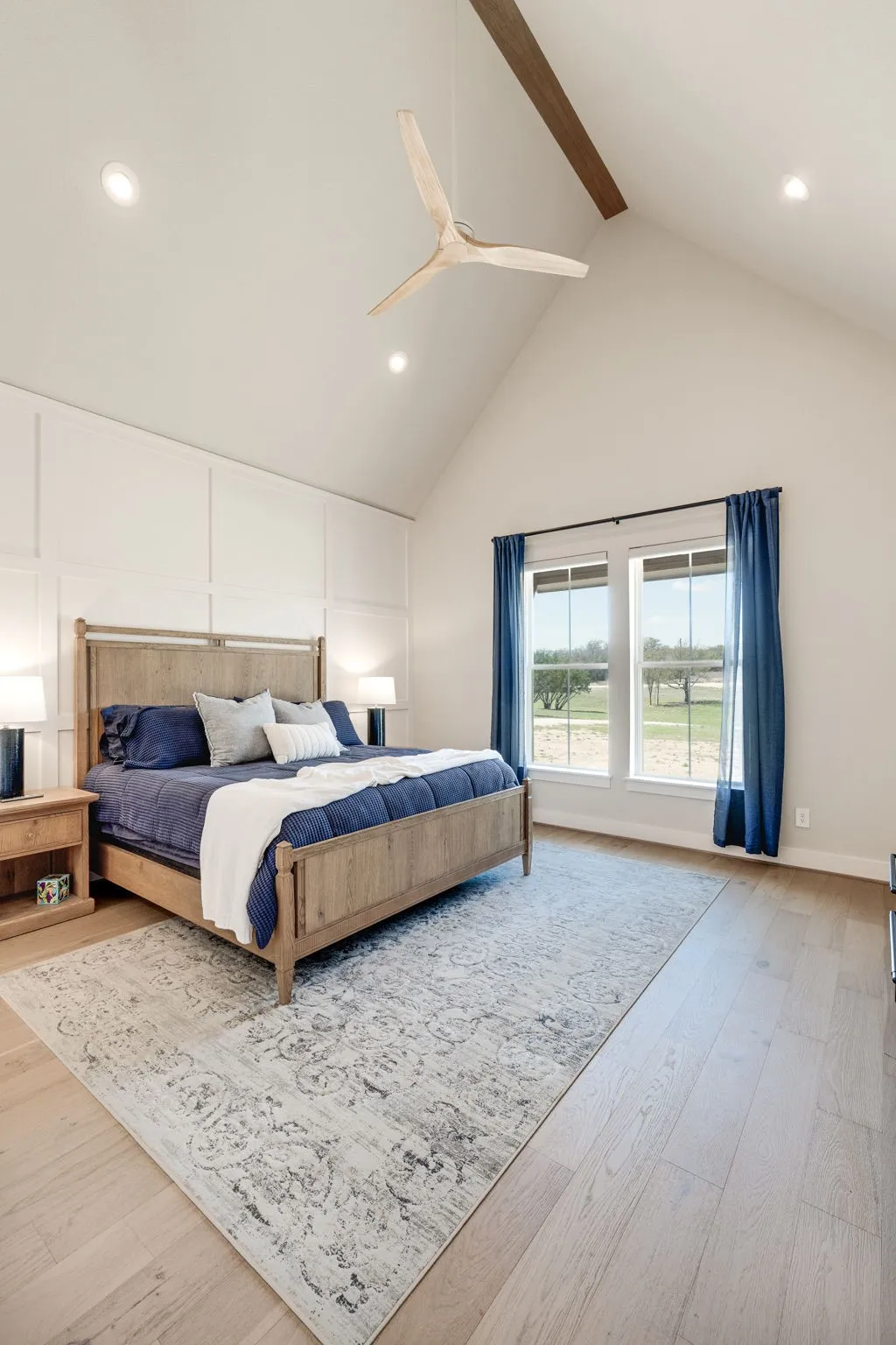 Bedroom with recessed lighting, light wood-type flooring, a ceiling fan, and a decorative wall
