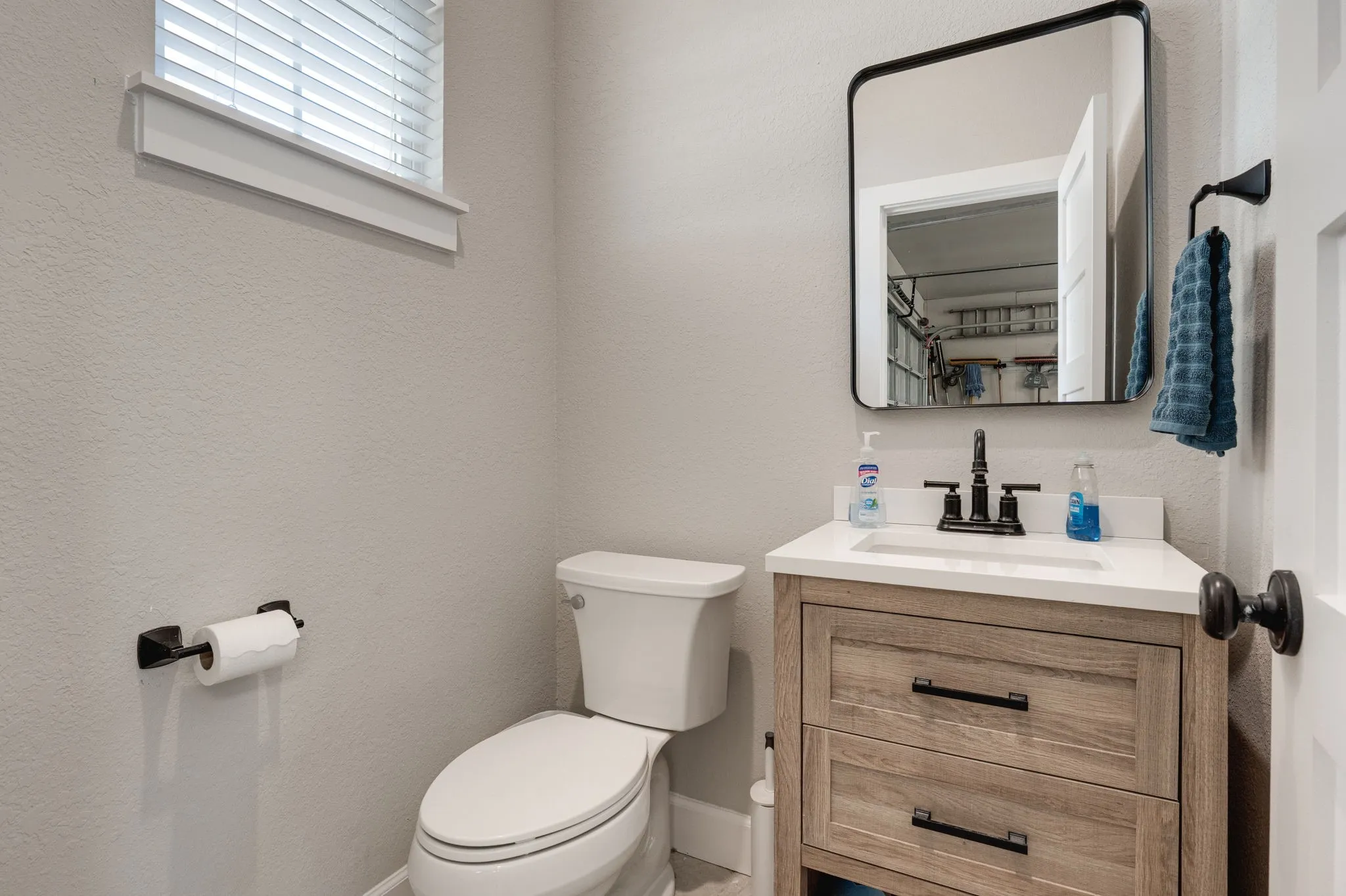 Bathroom with vanity and a textured wall