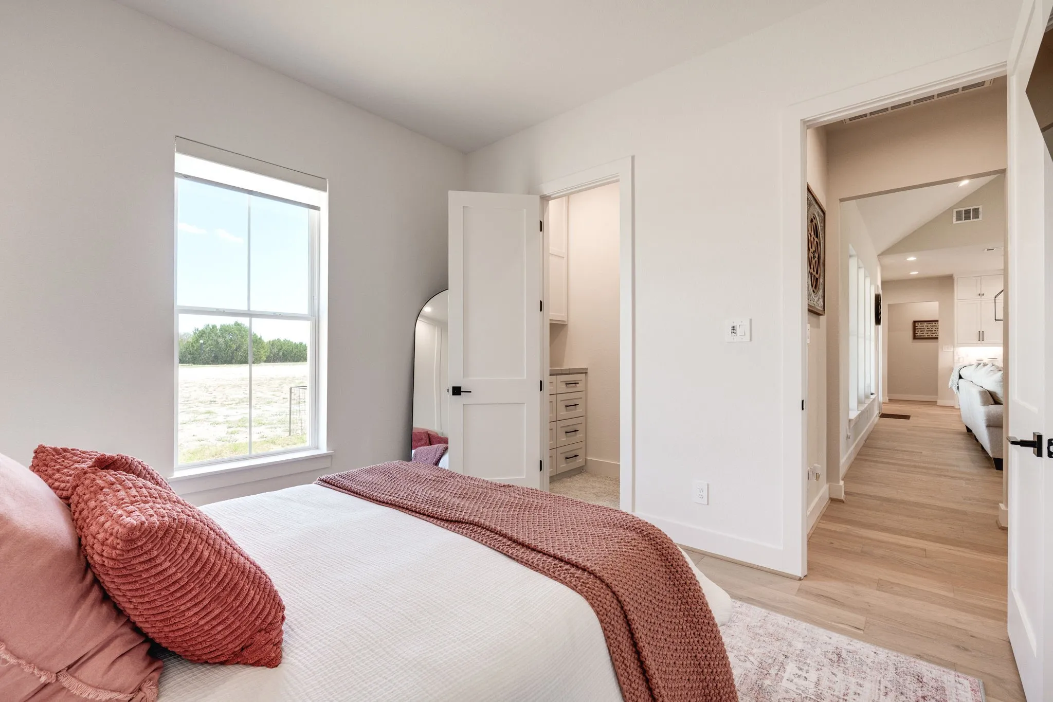Bedroom with a spacious closet and light wood-style floors