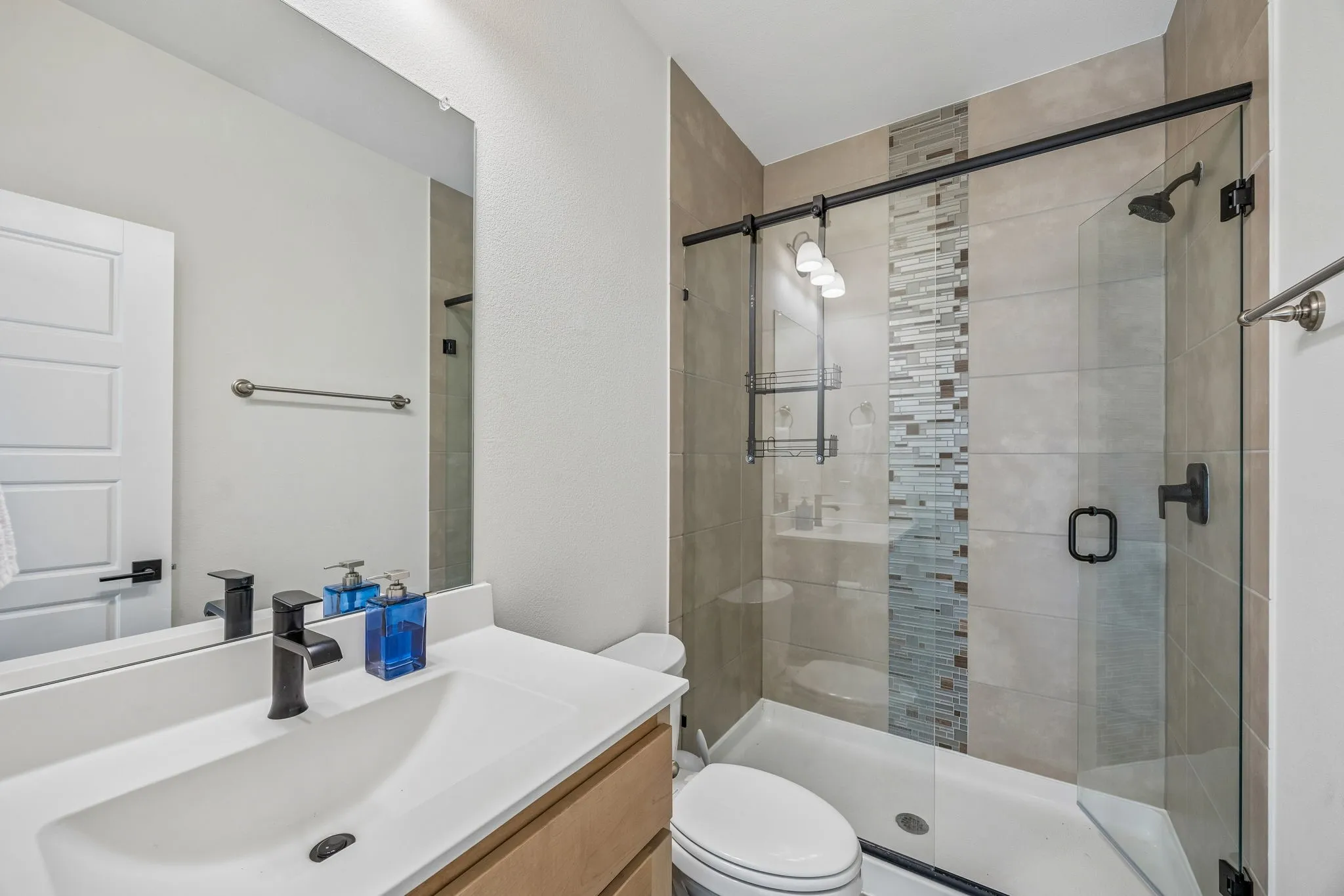 Bathroom with vanity and a shower stall