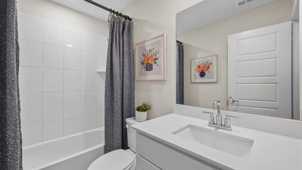 Full bath with shower / tub combo with curtain and vanity