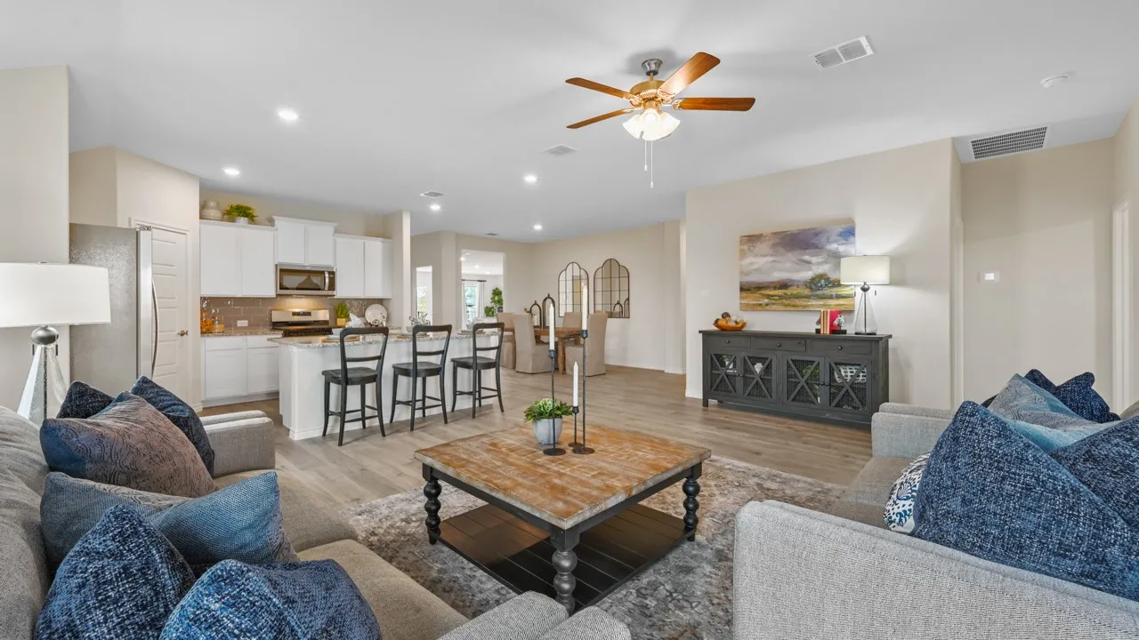 Living area with light wood-style floors, ceiling fan, and recessed lighting