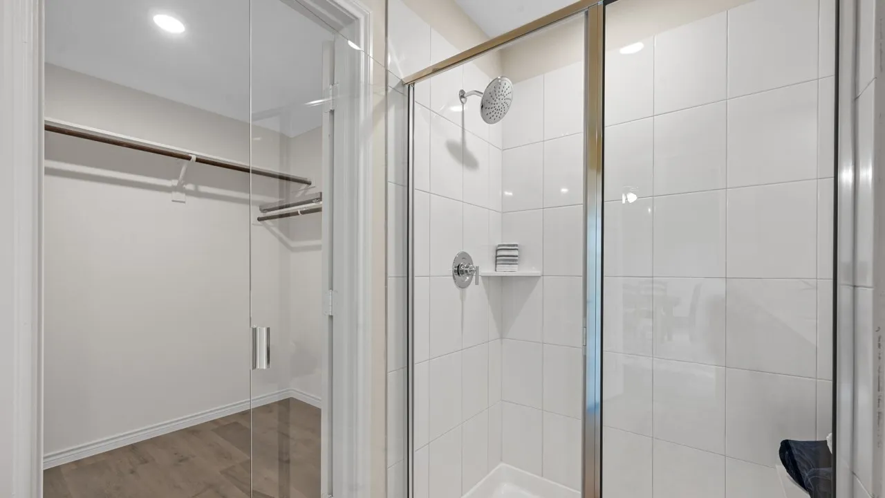 Full bathroom featuring a shower stall, light wood-type flooring, a walk in closet, and recessed lighting