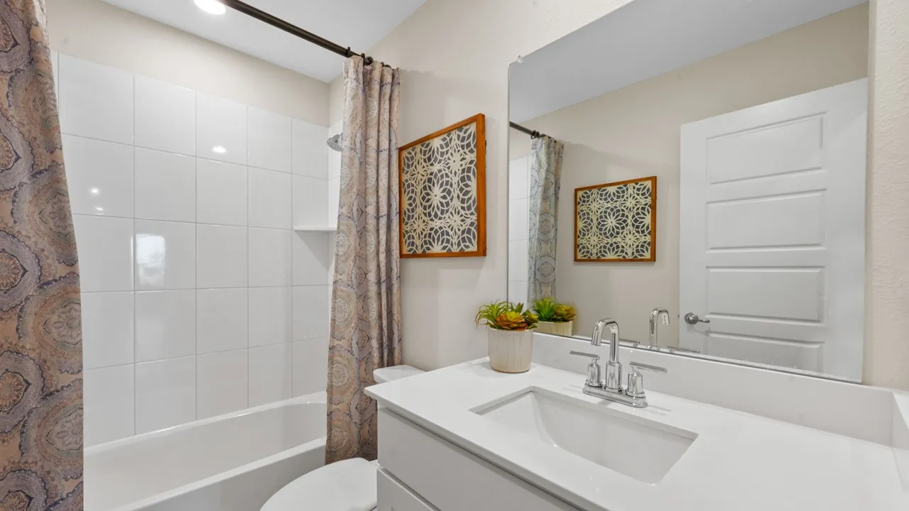 Bathroom featuring vanity and shower / tub combo