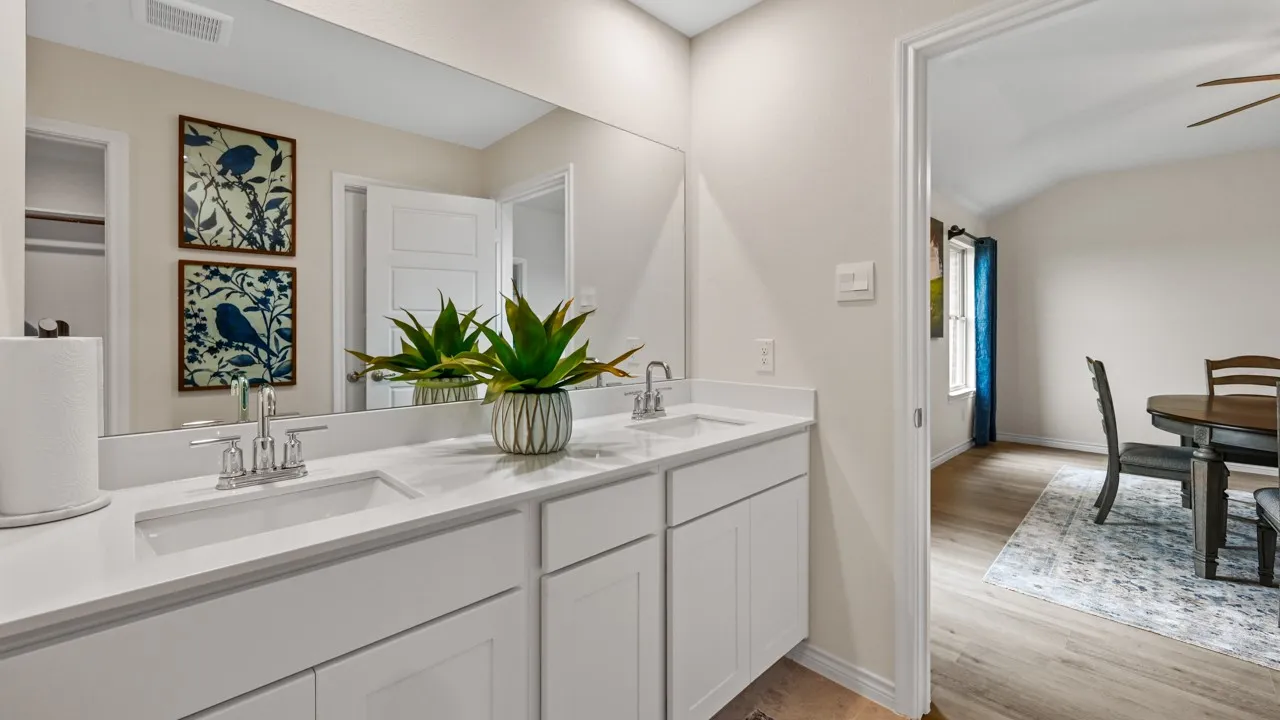 Bathroom featuring double vanity, light wood finished floors, and ceiling fan