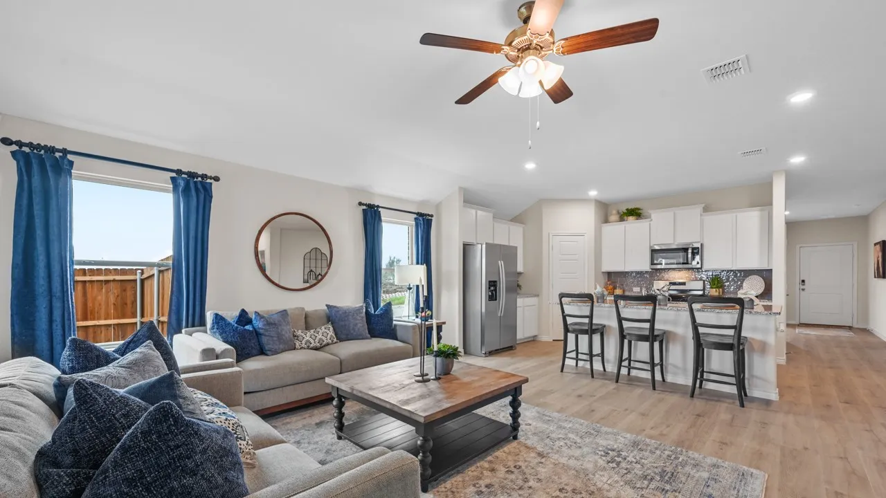 Living room with a ceiling fan, recessed lighting, and light wood finished floors
