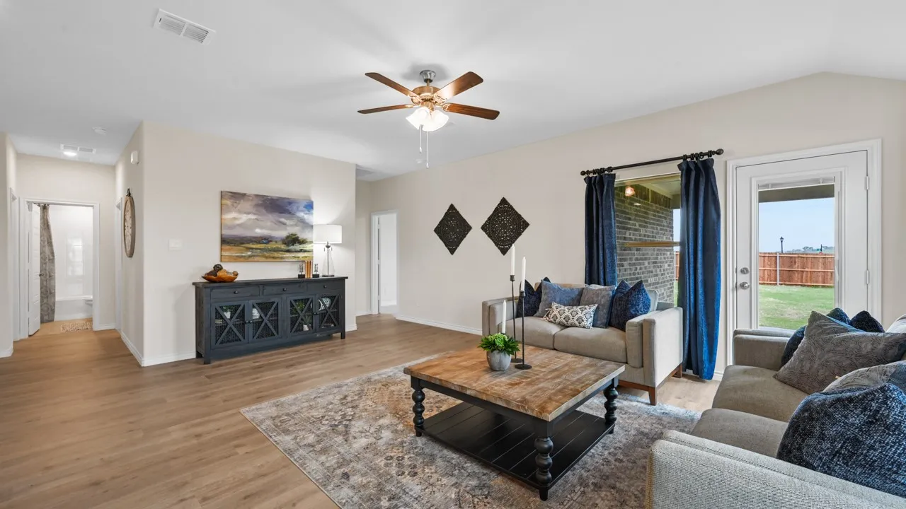 Living room featuring light wood-style floors and a ceiling fan