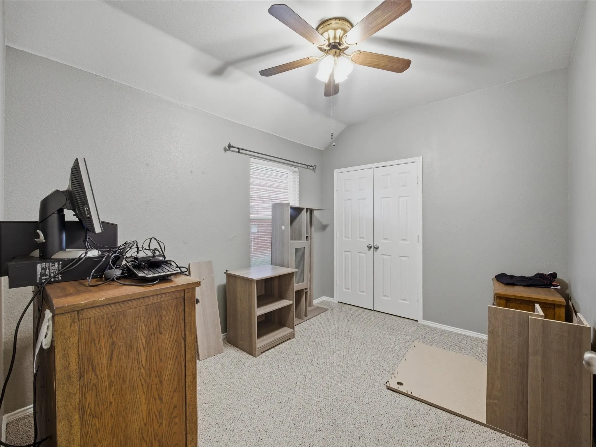Bedroom 2 featuring light carpet, lofted ceiling, and a ceiling fan