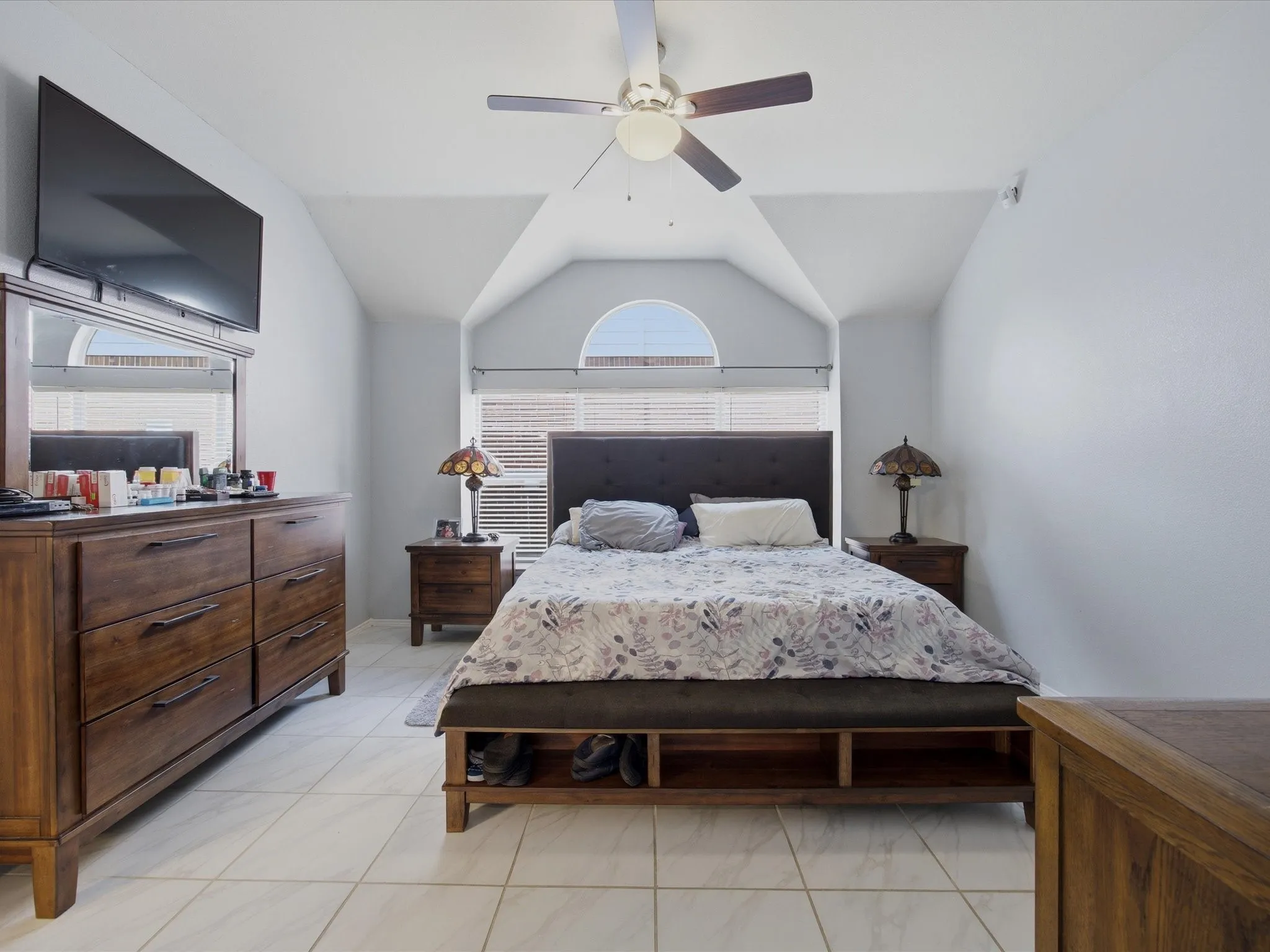 Master Bedroom with vaulted ceiling, a ceiling fan, and light tile patterned floors