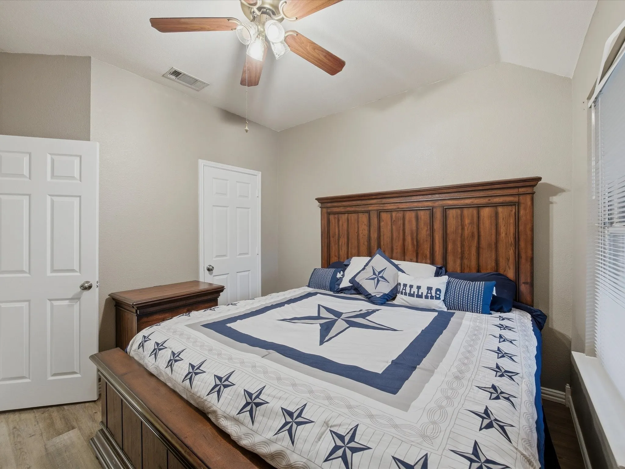 Bedroom 3 with vaulted ceiling, wood finished floors, and a ceiling fan