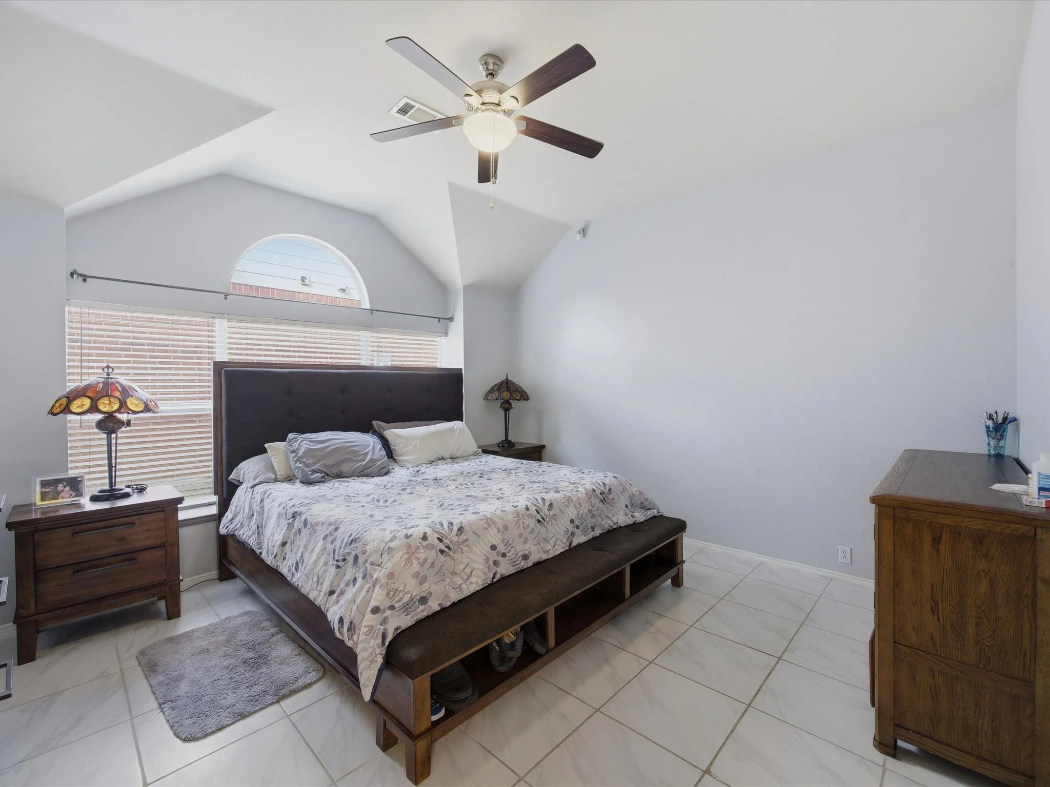Bedroom with lofted ceiling and a ceiling fan