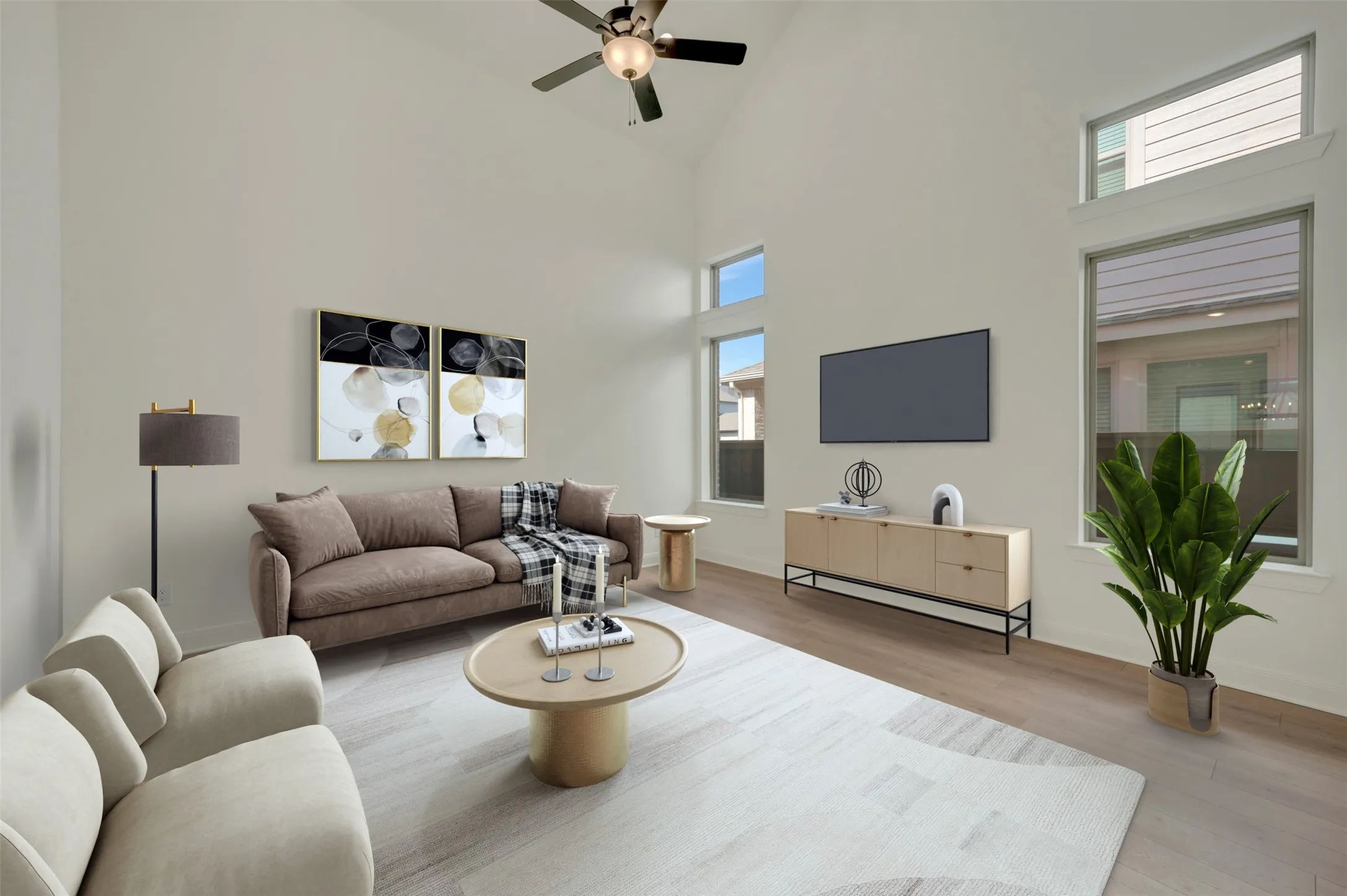 Living area featuring a vaulted ceiling and a ceiling fan with integrated lighting