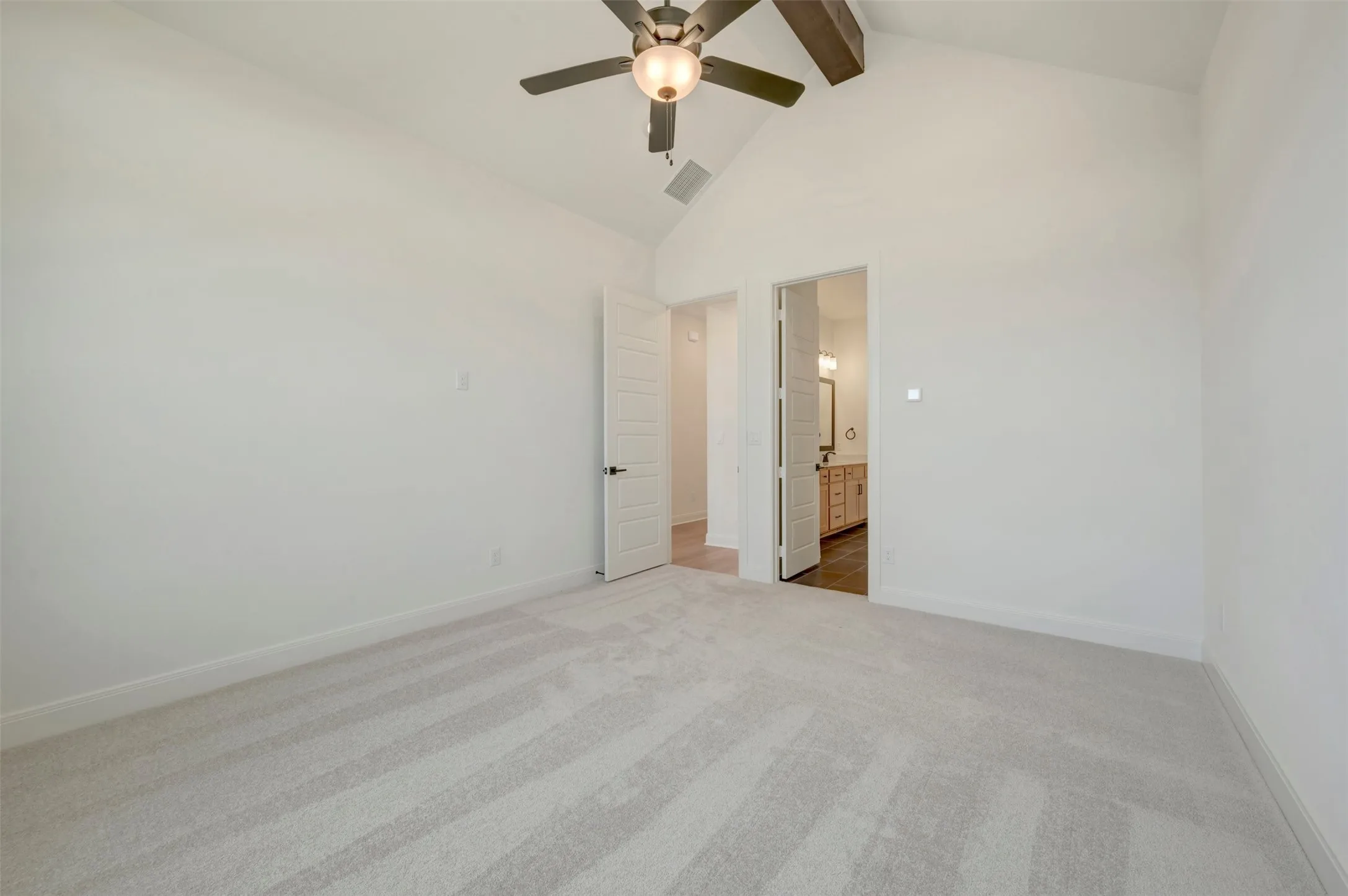 Vaulted ceiling featuring a ceiling fan with light fixture