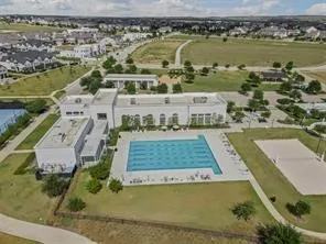 Aerial view of property and surrounding area featuring a pool area