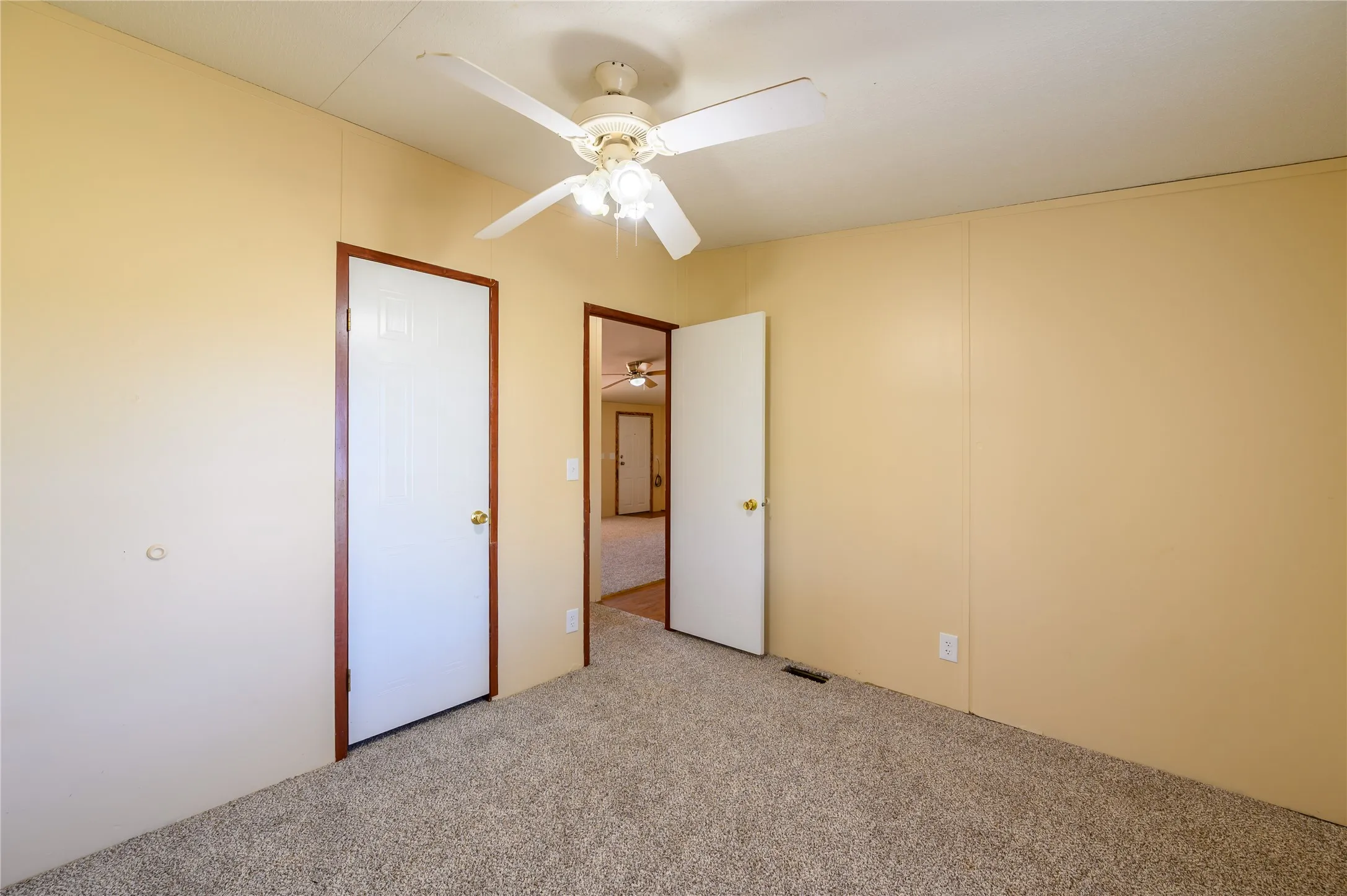 Unfurnished bedroom with carpet and ceiling fan