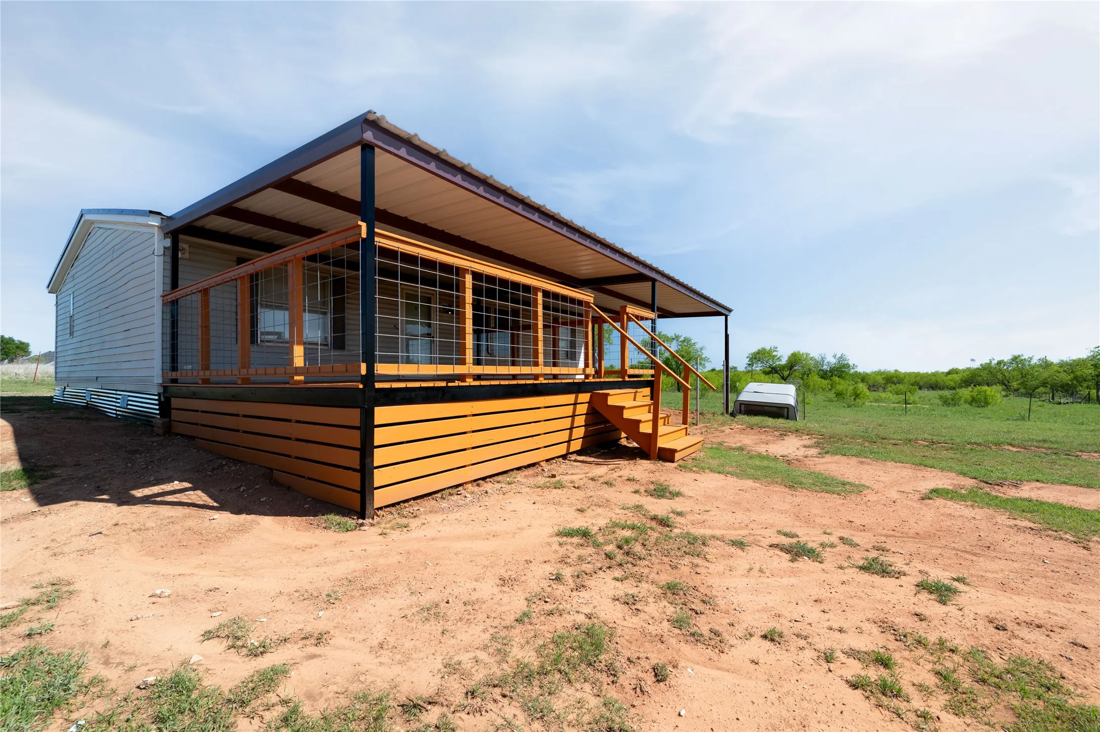 Manufactured home with large deck for entertaining.