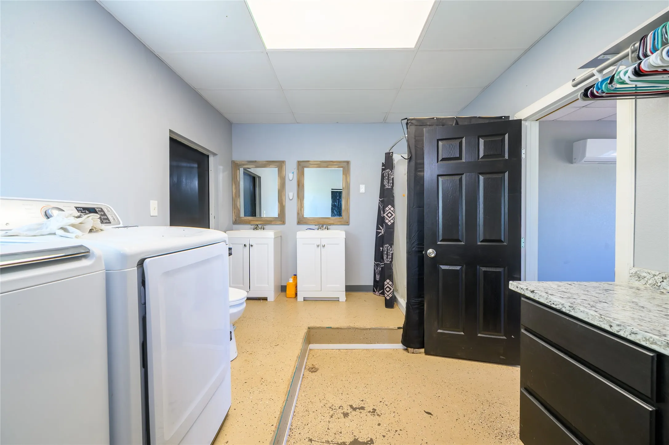 Laundry area featuring a paneled ceiling and separate washer and dryer
