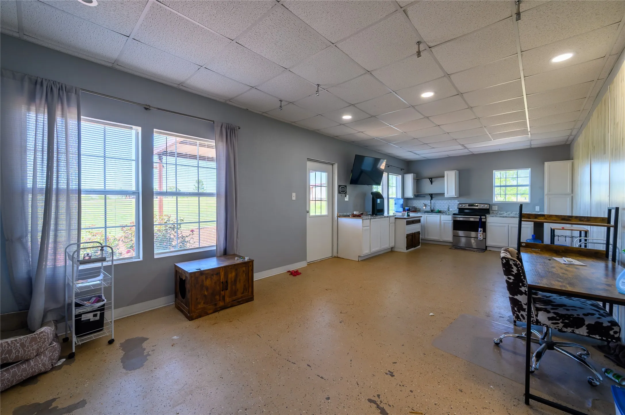Dining space with a paneled ceiling and recessed lighting