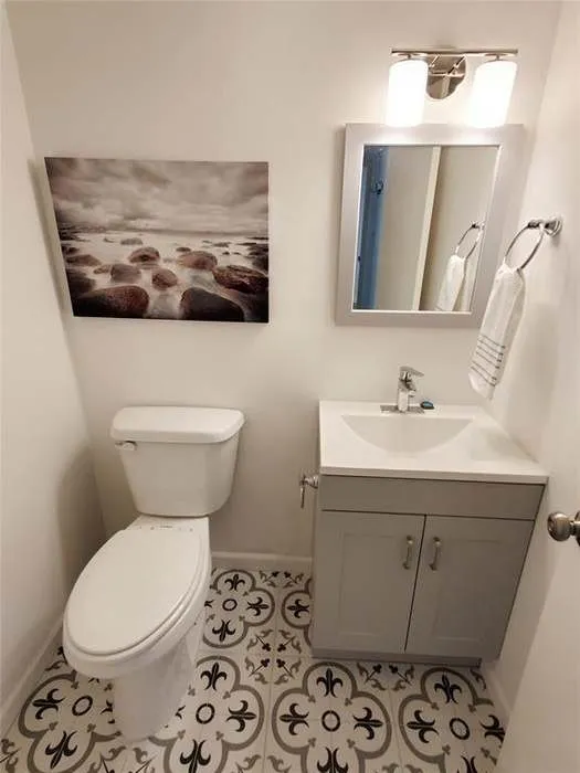 Half bath featuring vanity and light tile patterned floors