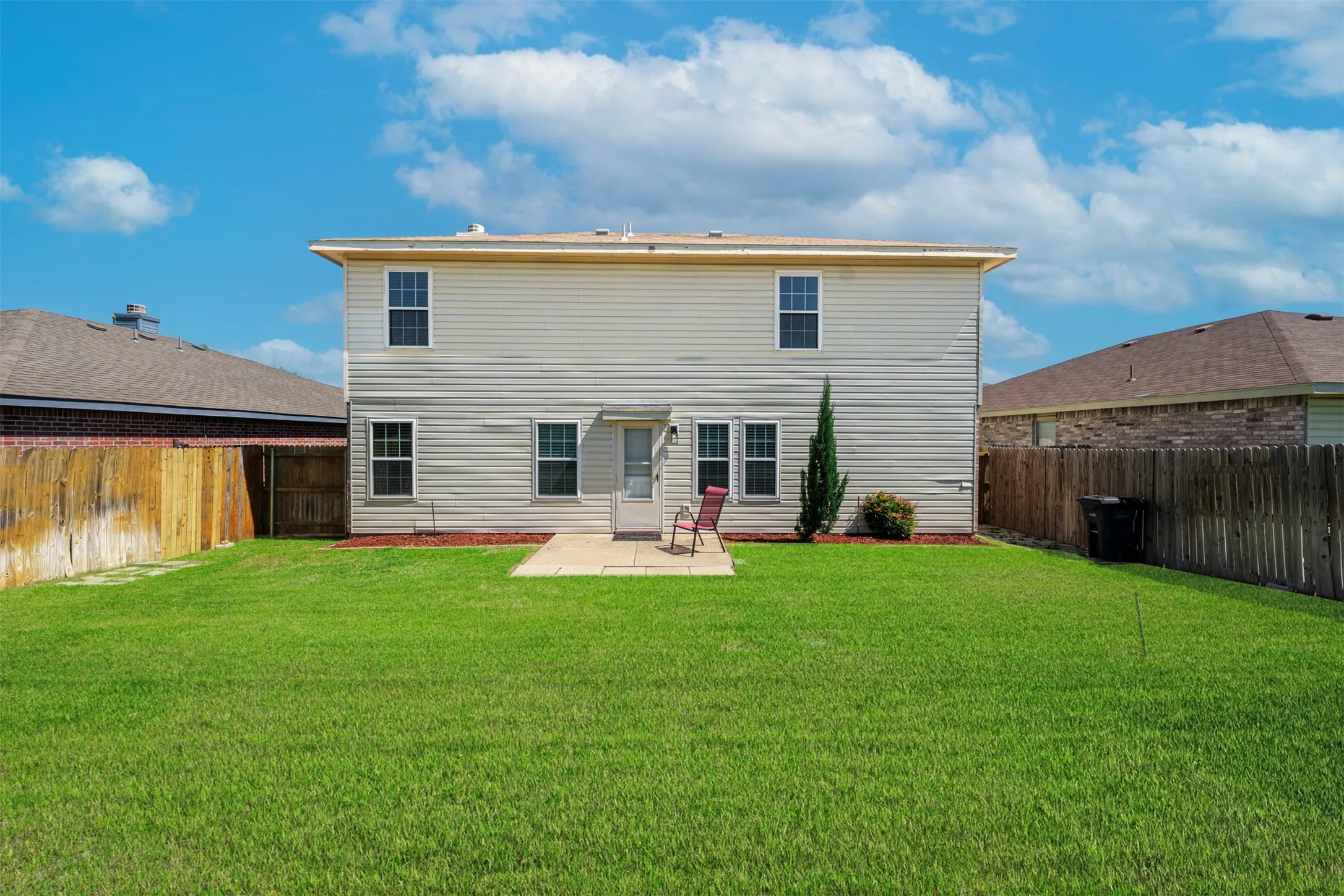Rear view of house with a patio and a fenced backyard
