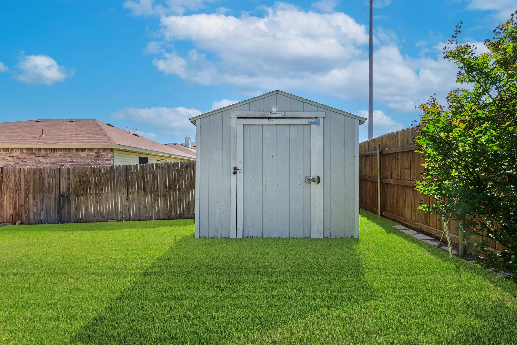 View of shed featuring a fenced backyard