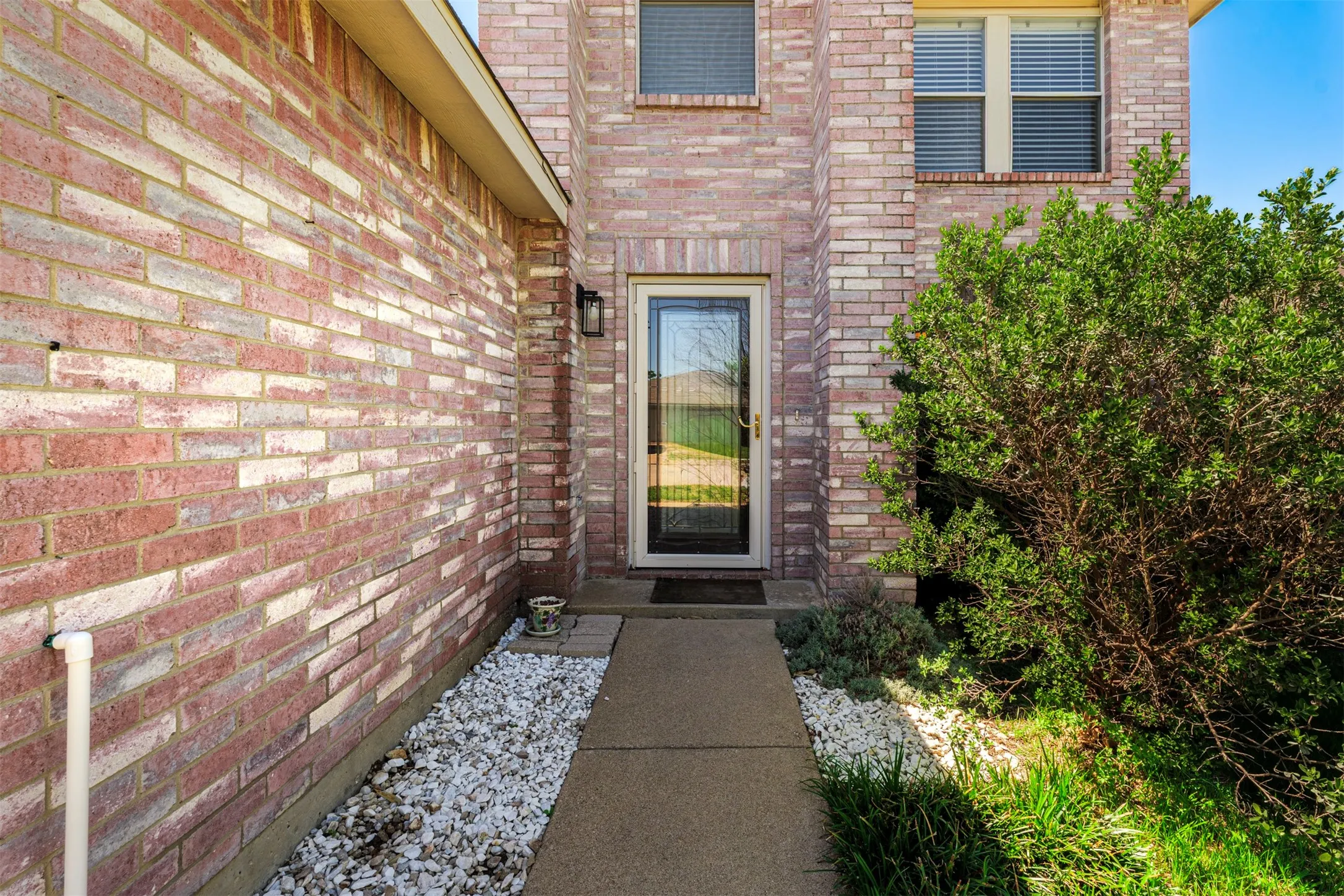 Entrance to property with brick siding
