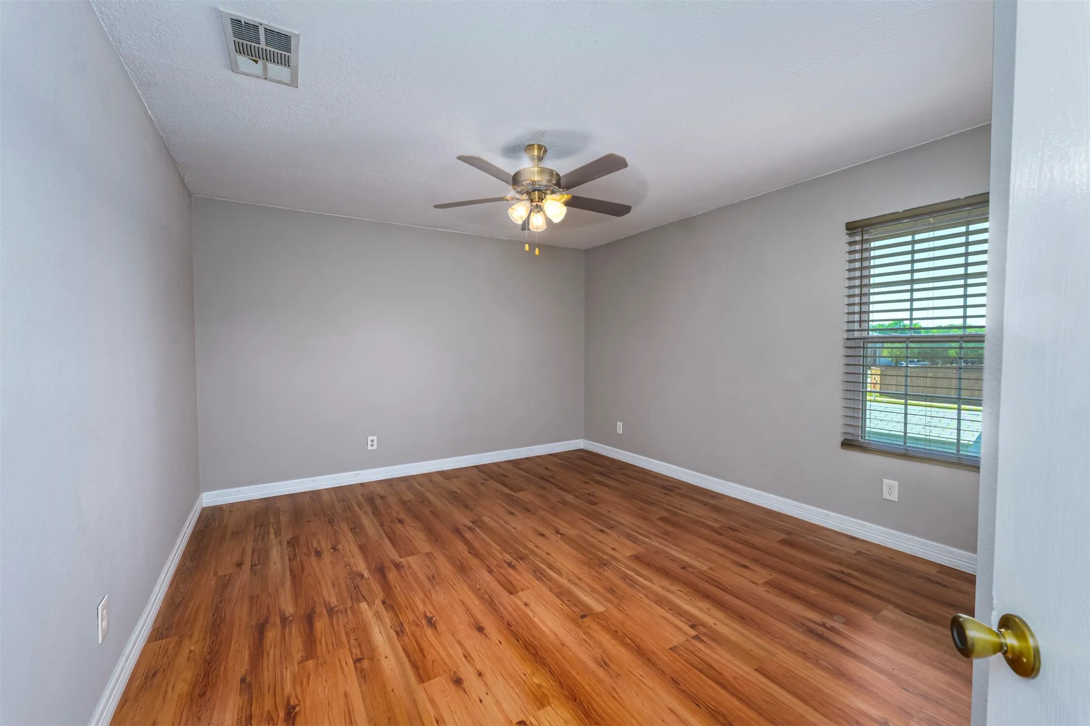 Spare room featuring wood finished floors and ceiling fan