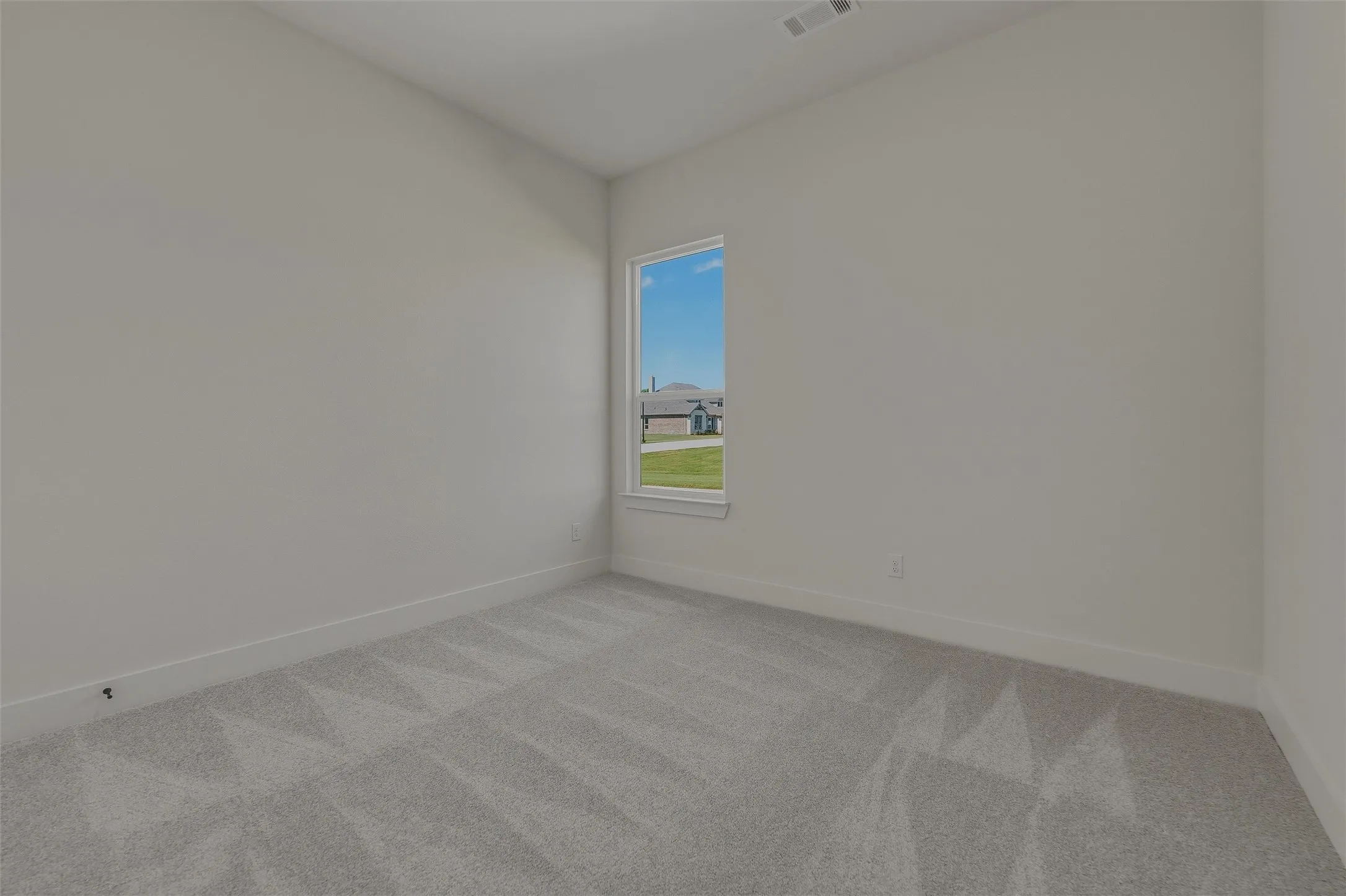 Light gray wall paint with white baseboards and window trim